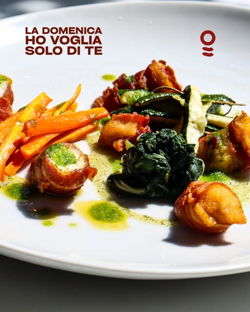 Involtini di pesce impiattati con verdure colorate, post Instagram Osteria Marconi
